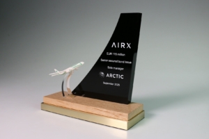 Aircraft-themed deal toy marking AIRX €115 million senior secured bond issue, featuring sculpted plane and acrylic fin.