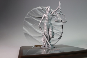 Lady Justice sculpture financial tombstone commemorating major legal and financial transaction.