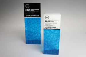 Custom Nissan Champions Awards acrylic trophies produced for annual dealer performance recognition.
