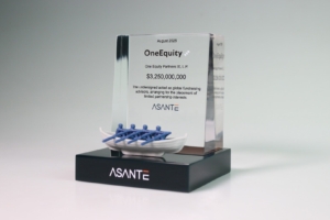 Acrylic financial tombstone celebrating One Equity Partners fundraising, featuring a symbolic rowing boat sculpture.