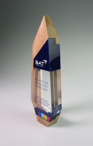 Custom financial tombstone award combining clear acrylic and wood, created to mark a regulatory landscape milestone.